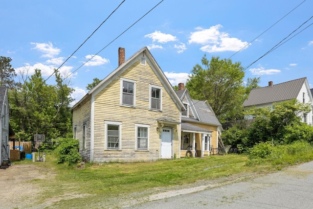 9 Laurel St, Whitefield, NH 03598 - view of front of property with a chimney and a front lawn