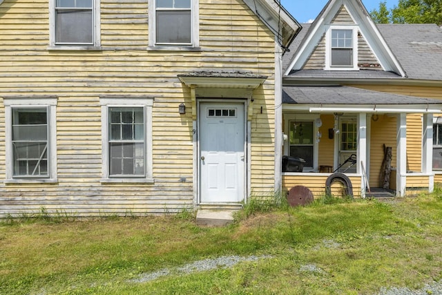 9 Laurel St, Whitefield, NH 03598 - townhome / multi-family property with a front lawn, a porch, and roof with shingles