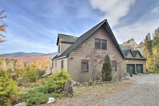 105 Valley View Rd, Easton, NH 03580 - view of home's exterior featuring a garage, gravel driveway, and a mountain view