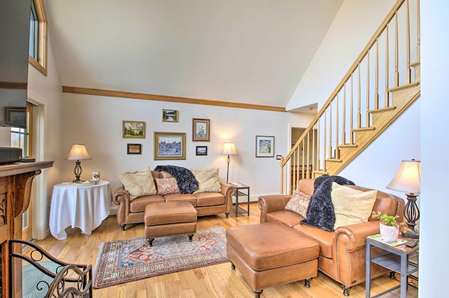 105 Valley View Rd, Easton, NH 03580 - living room with high vaulted ceiling, stairs, crown molding, baseboard heating, and wood finished floors
