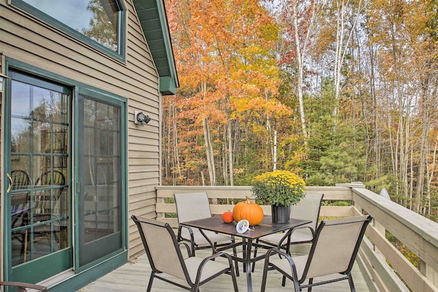 105 Valley View Rd, Easton, NH 03580 - wooden terrace with outdoor dining space and a wooded view