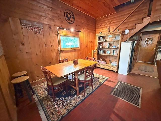 422/431 Little Rutland Rd, Castleton, VT 05735 - dining space featuring wooden walls, brick patterned floors, and wooden ceiling