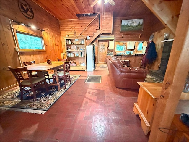 422/431 Little Rutland Rd, Castleton, VT 05735 - dining space featuring brick flooring, wood walls, wood ceiling, and stairs
