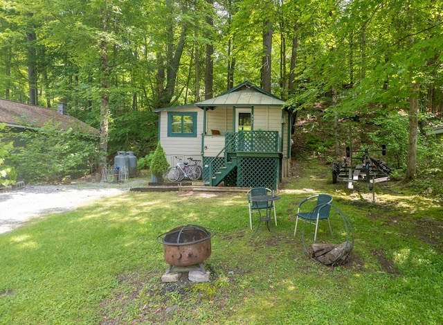 422/431 Little Rutland Rd, Castleton, VT 05735 - view of outdoor structure featuring a fire pit, stairs, and a view of trees