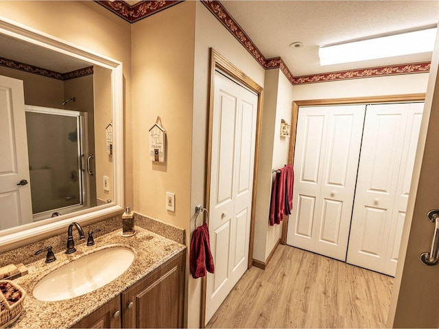 115 Meadow Run Rd, Williston, VT 05495 - bathroom featuring wood finished floors, vanity, a closet, and a textured ceiling