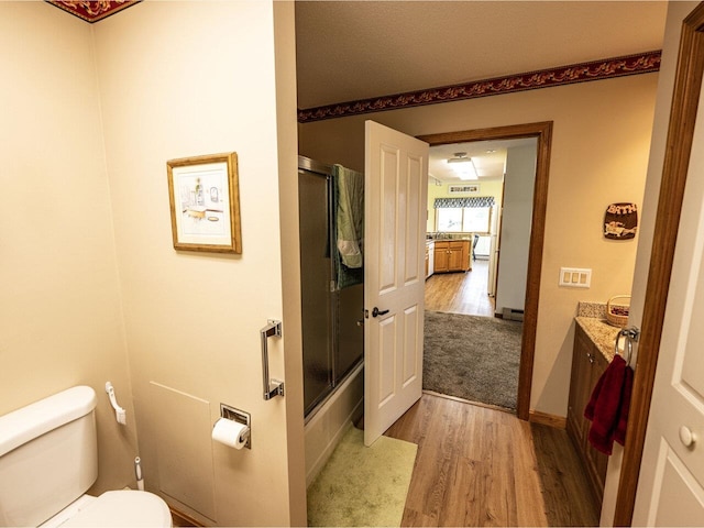 115 Meadow Run Rd, Williston, VT 05495 - bathroom featuring wood finished floors, vanity, toilet, and shower / bath combination with glass door