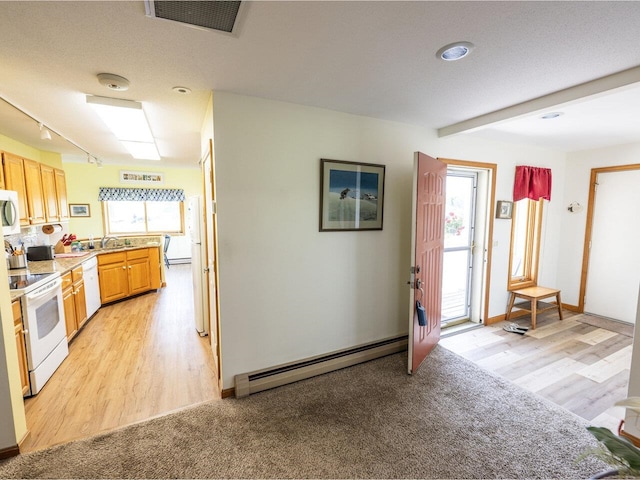 115 Meadow Run Rd, Williston, VT 05495 - kitchen featuring baseboard heating, white appliances, light wood-style flooring, light countertops, and a sink