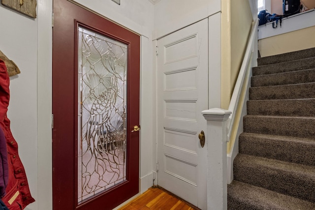 entryway with stairs and wood finished floors