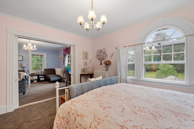 carpeted bedroom featuring a chandelier and crown molding