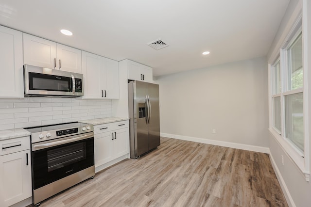 21 Ridgefield Dr, Milford, NH 03055 - kitchen with stainless steel appliances, light wood-style floors, tasteful backsplash, baseboards, and recessed lighting