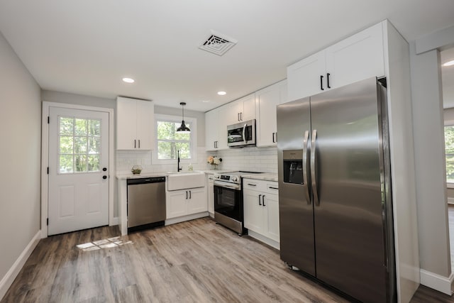 21 Ridgefield Dr, Milford, NH 03055 - kitchen featuring stainless steel appliances, a sink, baseboards, white cabinets, and recessed lighting