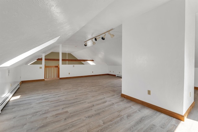 5 Lucerne Dr, Madison, NH 03849 - bonus room with lofted ceiling, wood finished floors, a baseboard radiator, baseboards, and a skylight
