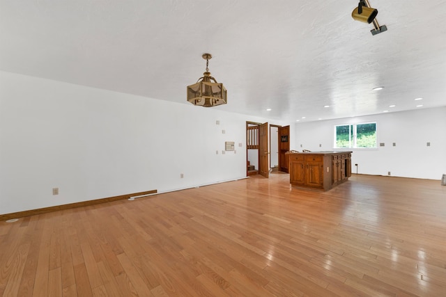 5 Lucerne Dr, Madison, NH 03849 - unfurnished living room featuring a chandelier and light wood finished floors