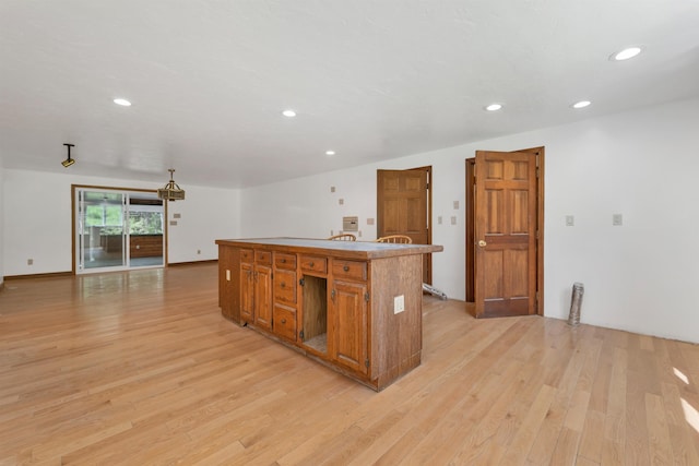 5 Lucerne Dr, Madison, NH 03849 - kitchen with light wood-style floors, recessed lighting, a kitchen island, open floor plan, and brown cabinets
