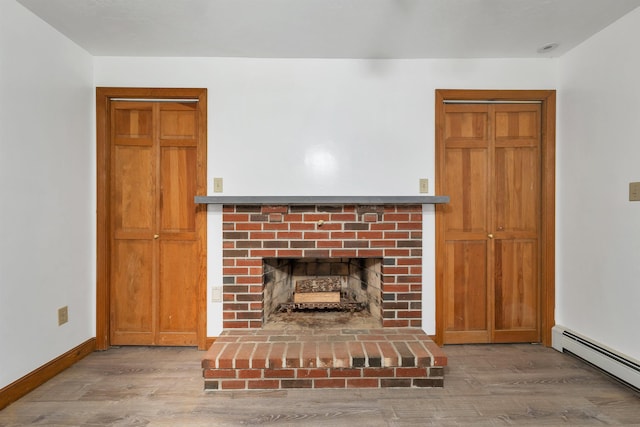 5 Lucerne Dr, Madison, NH 03849 - unfurnished living room featuring baseboard heating, wood finished floors, a fireplace, and baseboards