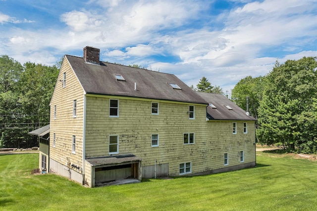 5 Lucerne Dr, Madison, NH 03849 - rear view of house featuring a chimney, a lawn, and a shingled roof