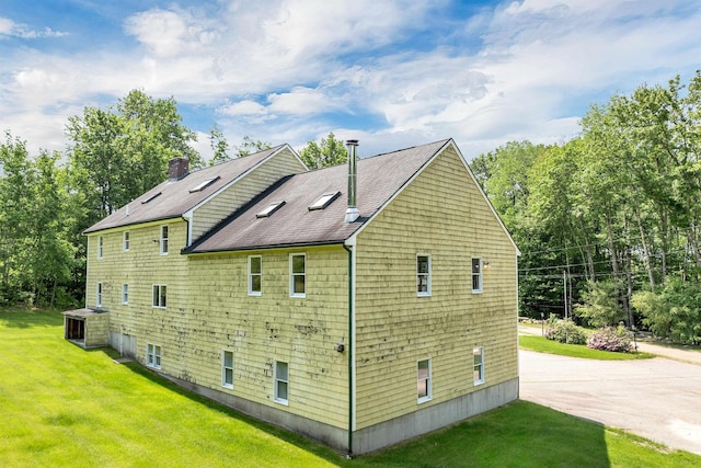 5 Lucerne Dr, Madison, NH 03849 - view of side of property with roof with shingles, a lawn, and a chimney