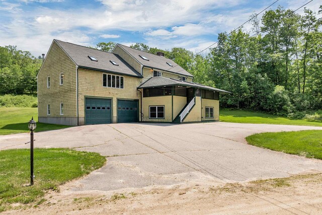 5 Lucerne Dr, Madison, NH 03849 - view of property exterior featuring an attached garage, driveway, a lawn, stairway, and roof with shingles