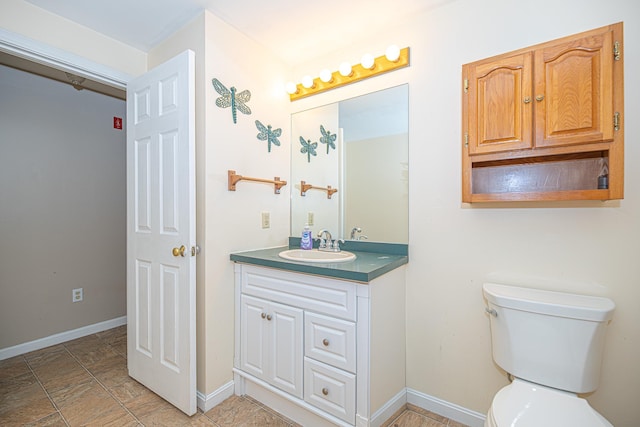 20 Locke Hill Ln, Barrington, NH 03825 - bathroom featuring vanity, toilet, baseboards, and stone finish floors