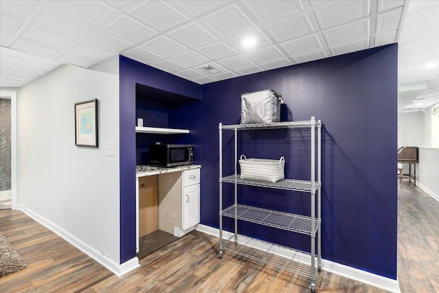 6 Samuels Ct, Dunbarton, NH 03046 - bar area with baseboards, wood finished floors, stainless steel microwave, built in study area, and recessed lighting