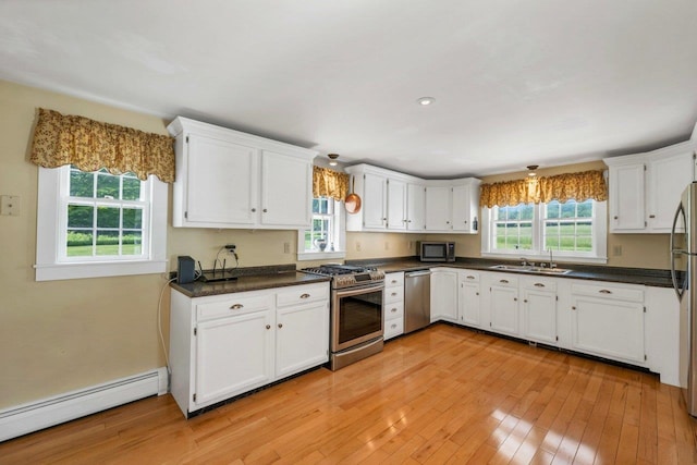 196 Deering Center Rd, Weare, NH 03281 - kitchen featuring stainless steel appliances, a baseboard radiator, white cabinets, and light wood-style flooring