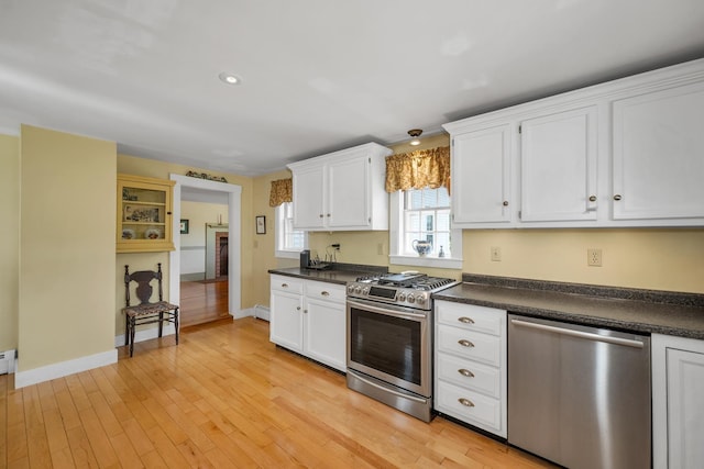 196 Deering Center Rd, Weare, NH 03281 - kitchen with appliances with stainless steel finishes, dark countertops, light wood-style floors, and recessed lighting