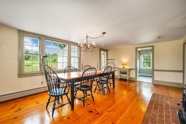 196 Deering Center Rd, Weare, NH 03281 - dining area with a chandelier, a baseboard heating unit, and hardwood / wood-style flooring