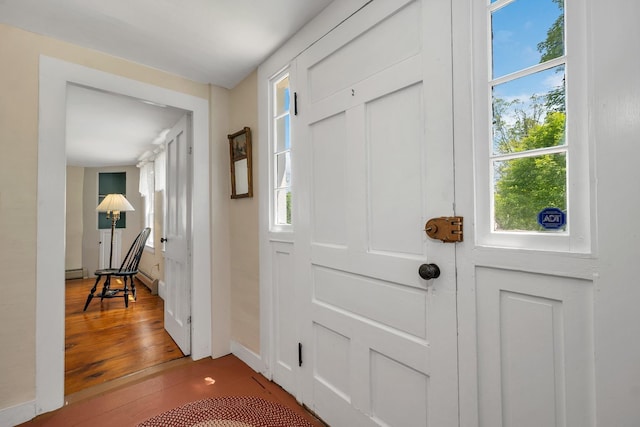 196 Deering Center Rd, Weare, NH 03281 - foyer featuring healthy amount of natural light, wood finished floors, baseboards, and a baseboard heating unit