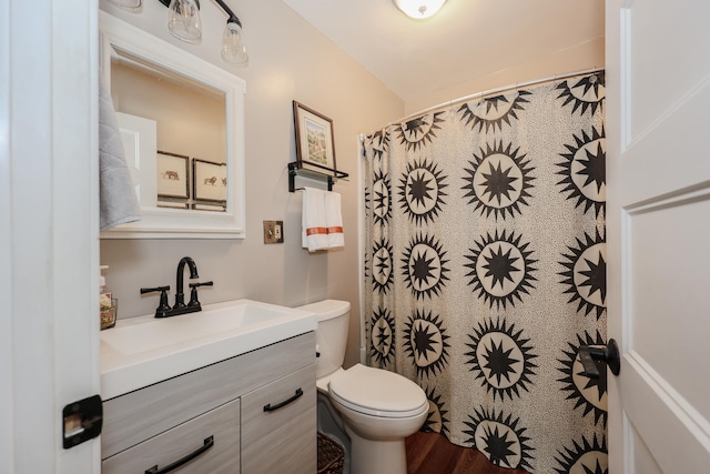 864 Cilley Rd, Manchester, NH 03103 - bathroom with vanity, toilet, wood finished floors, and curtained shower