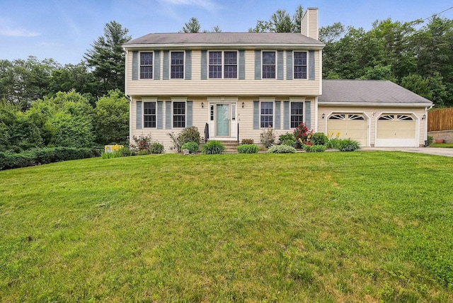 18 Bear Path Ln, Hudson, NH 03055 - colonial inspired home featuring a garage, a chimney, asphalt driveway, and a front lawn