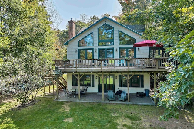 7 Acorn Dr, Alton, NH 03810 - back of house featuring a wooden deck, a lawn, a patio, and a chimney