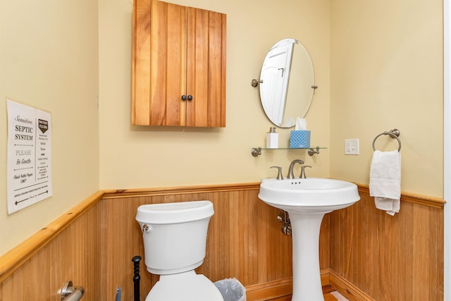 7 Acorn Dr, Alton, NH 03810 - bathroom featuring a wainscoted wall, toilet, and wooden walls