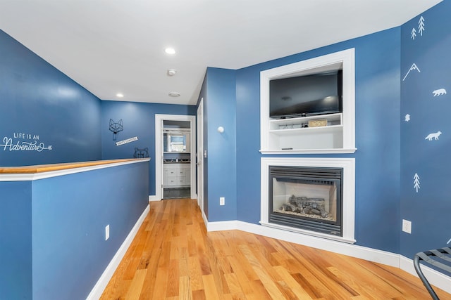 7 Acorn Dr, Alton, NH 03810 - unfurnished living room with wood finished floors, baseboards, a glass covered fireplace, and recessed lighting
