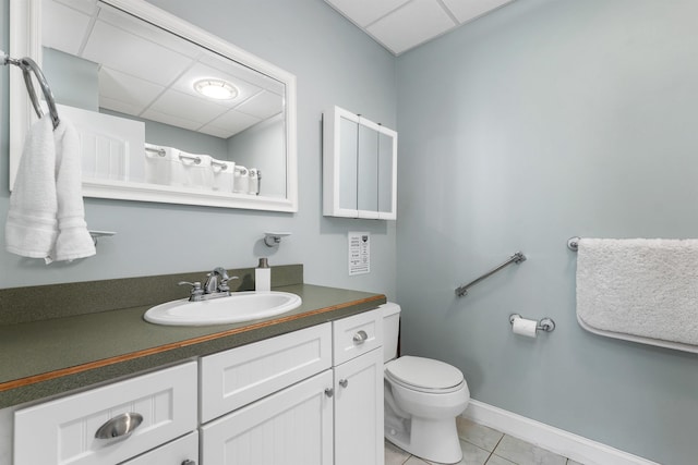 7 Acorn Dr, Alton, NH 03810 - bathroom with vanity, a drop ceiling, toilet, tile patterned floors, and baseboards