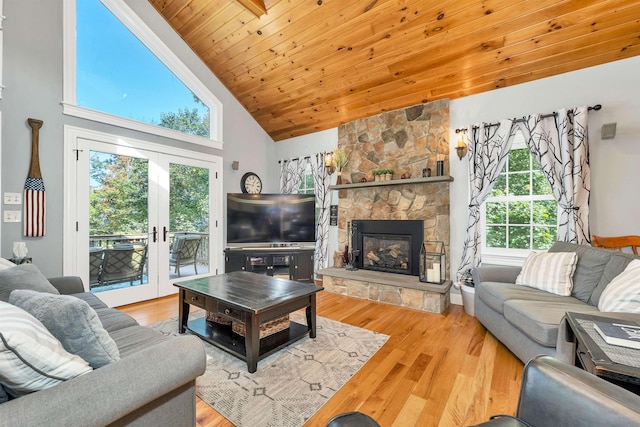 7 Acorn Dr, Alton, NH 03810 - living area with wood finished floors, a fireplace, wood ceiling, high vaulted ceiling, and french doors