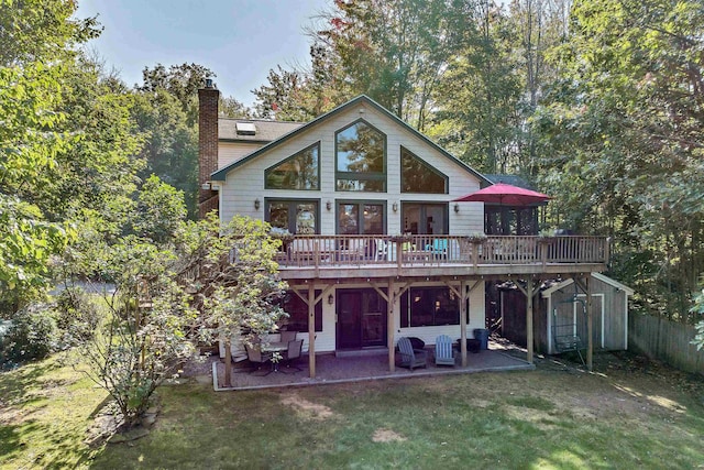 7 Acorn Dr, Alton, NH 03810 - rear view of house with a deck, a yard, a chimney, a patio, and an outdoor structure