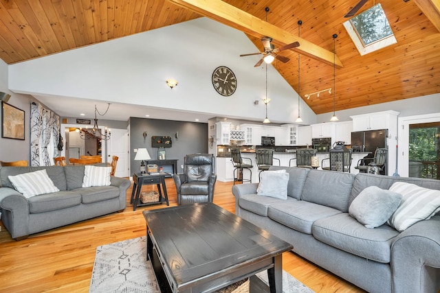7 Acorn Dr, Alton, NH 03810 - living room with high vaulted ceiling, a ceiling fan, a chandelier, light wood finished floors, and a skylight