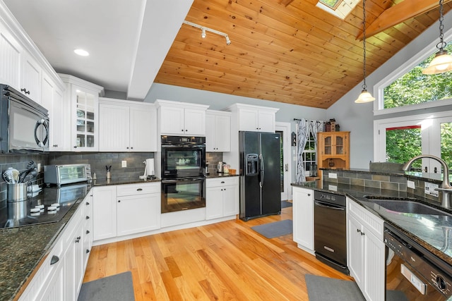 7 Acorn Dr, Alton, NH 03810 - kitchen with black appliances, a sink, vaulted ceiling, white cabinetry, and light wood-type flooring