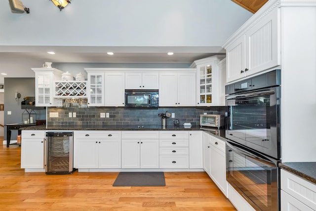 7 Acorn Dr, Alton, NH 03810 - kitchen featuring wine cooler, black appliances, light wood-style flooring, recessed lighting, and decorative backsplash