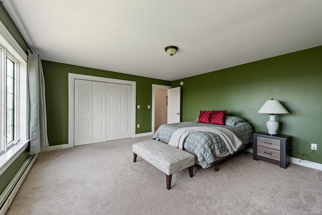 33 Winterberry Ln, Plymouth, NH 03264 - bedroom featuring baseboard heating, light colored carpet, a closet, and baseboards