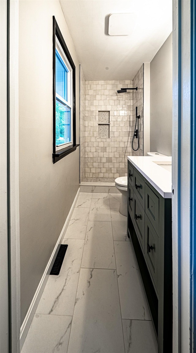 110 Currier Rd, Candia, NH 03034 - full bath with marble look tiles, toilet, tiled shower, vanity, and baseboards