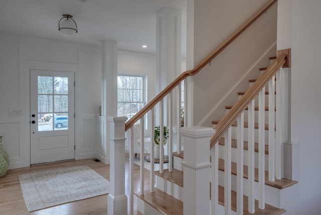 338 Pine Hill Rd, Hollis, NH 03049 - foyer entrance featuring plenty of natural light, wood finished floors, a decorative wall, and stairway