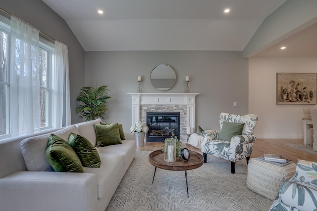 338 Pine Hill Rd, Hollis, NH 03049 - living room featuring vaulted ceiling, light wood-type flooring, a stone fireplace, recessed lighting, and baseboards