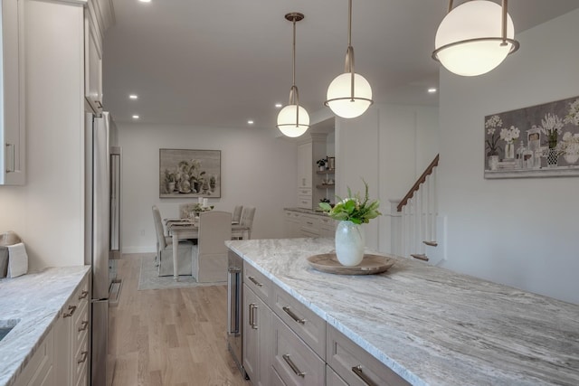 338 Pine Hill Rd, Hollis, NH 03049 - kitchen with recessed lighting, freestanding refrigerator, light stone countertops, light wood-style flooring, and hanging light fixtures