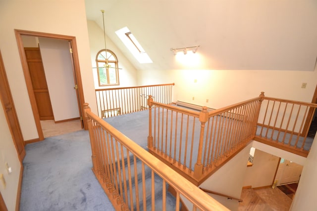 296 Atwood Rd, Duxbury, VT 05676 - hall with a skylight, an upstairs landing, vaulted ceiling, carpet, and baseboards