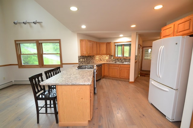 296 Atwood Rd, Duxbury, VT 05676 - kitchen featuring stainless steel appliances, a kitchen breakfast bar, light wood-type flooring, recessed lighting, and tasteful backsplash
