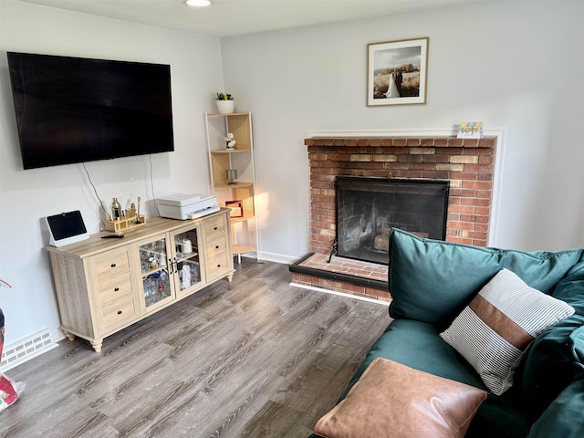 22 Sanborn Rd, Hampton, NH 03842 - living area with wood finished floors, a brick fireplace, recessed lighting, and baseboards