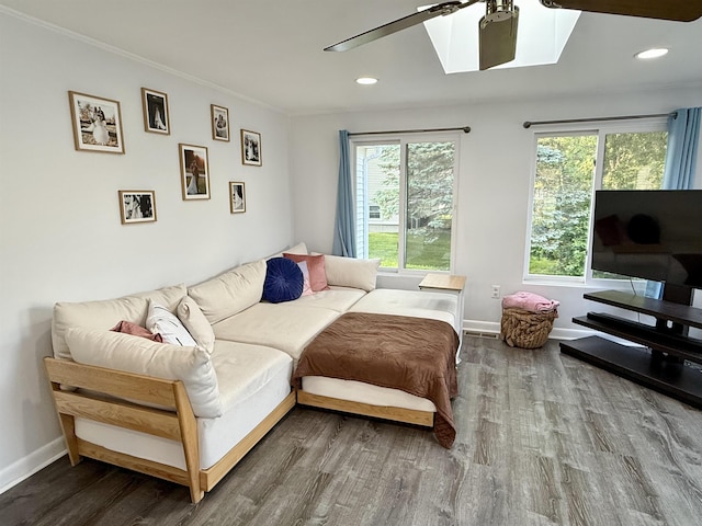 22 Sanborn Rd, Hampton, NH 03842 - living room with wood finished floors, a skylight, baseboards, recessed lighting, and ornamental molding