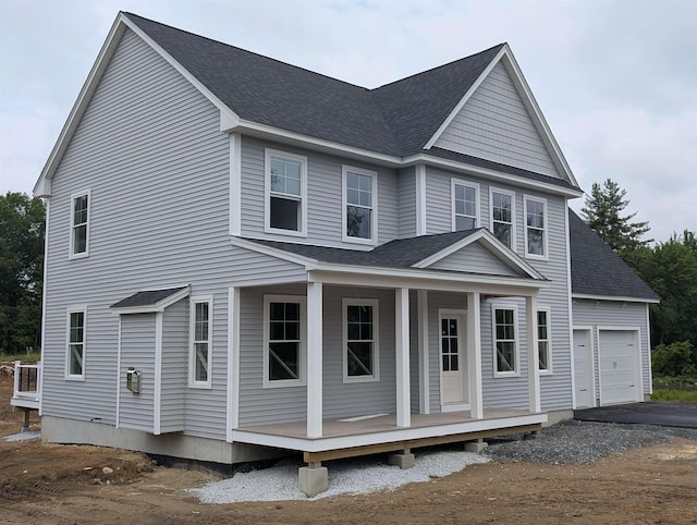 LOT7-3 Sanborn Mdw Unit 7-3, Fremont, NH 03044 - view of front facade featuring a porch, a garage, a shingled roof, and asphalt driveway