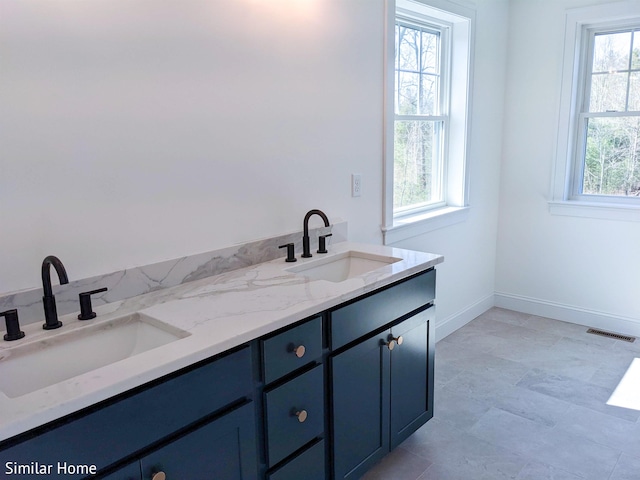 LOT7-3 Sanborn Mdw Unit 7-3, Fremont, NH 03044 - bathroom with double vanity and baseboards